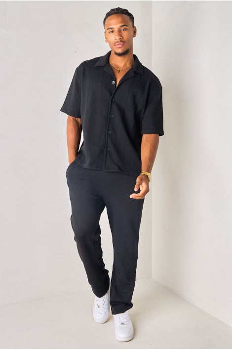 Pantalon coupe droite noir en tissu texturé et ajouré